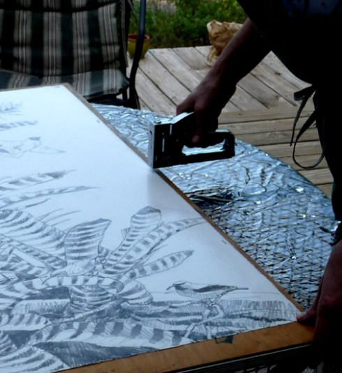 I lifted up the wet paper and Tim slid the wooden board underneath like a peel under a hot pizza. Once it was on, it got stapled down to hold it in place and dry nice and tight.