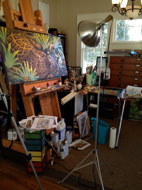 I've got a clamp-on gooseneck daylight lamp that illuminates one small patch at a time. Not good. You want a daylight lamp on a moveable stand. This one's got a 150 watt bulb in a reflector with a wooden handle at the back end so you don't burn your fingers when you turn it. It's actually got a clever ball joint at the top of the stand which puts it a few steps above the usual clamp lamp.