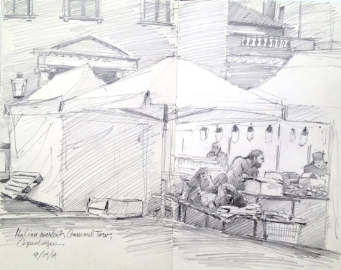 Merchant takes a nap behind the cheese tent at an Italian street market in Gammeltorv, the old square in Copenhagen. Heaps of sun-dried tomatoes, piles of olives, strings of salamis, bins of biscuits and cookies and sweets, giant wheels of parmesan, dried pasta, baskets of spices.  