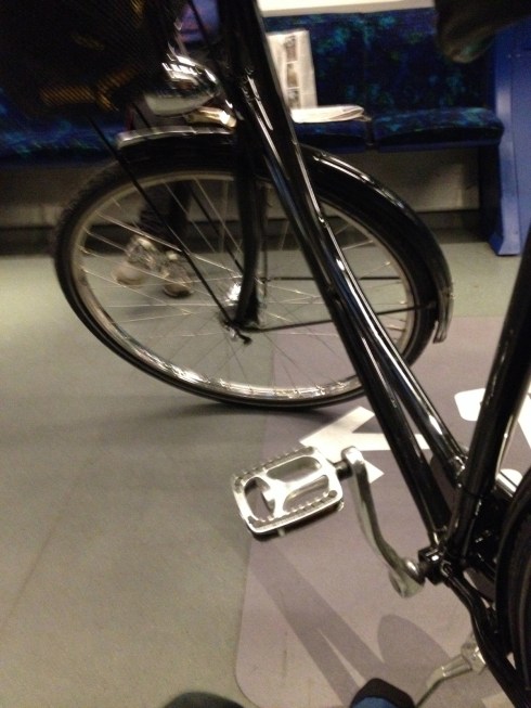 I swear I'm going to upload a step-by-step tutorial on how to actually, physically, take your bike on the S-Train. It's a great service, goes everywhere, works wonderfully, but if you don't know the ins and outs, you're going to screw it up. If you're anything like me, that is. That's my bike. It's on the S-Train. I'm sitting next to it, making sure it doesn't fall over, even though it's fairly securely engaged with the rear-tire clamp rack. The first time I used it, my bike fell onto the expensive roadster next to it, earning me a dirty look from its owner. So it goes. 